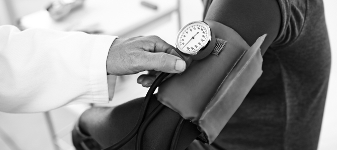 African-American person getting blood pressure checked