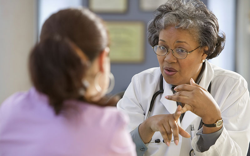 middle-aged doctor counsels patient