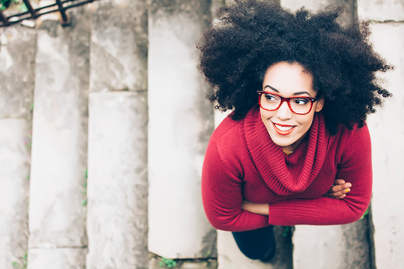 woman in red sweater on stairs overhead view
