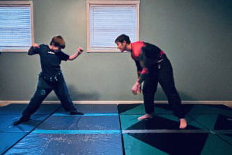 Chris and his son practicing Jiu Jitsu