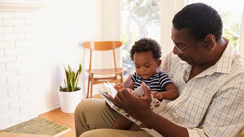 grandfather and grandson reading book