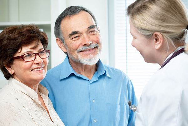 senior couple talking to doctor senior couple talking to doctor