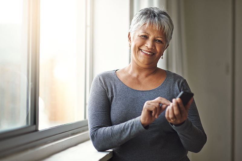 happy senior woman on smart phone
