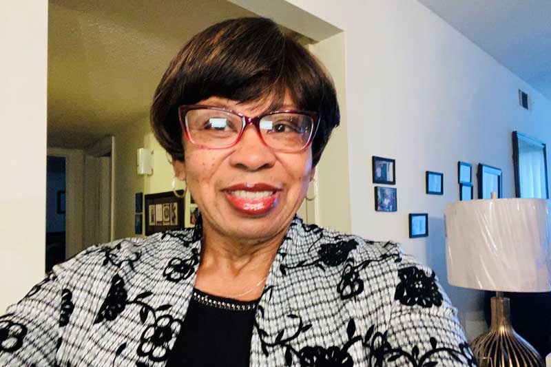 Lynn Amos smiling in her home