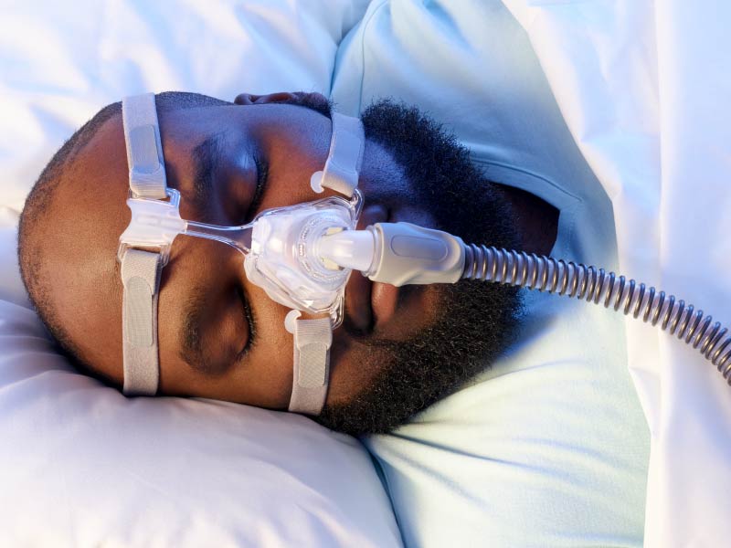 African-American man with CPAP mask.