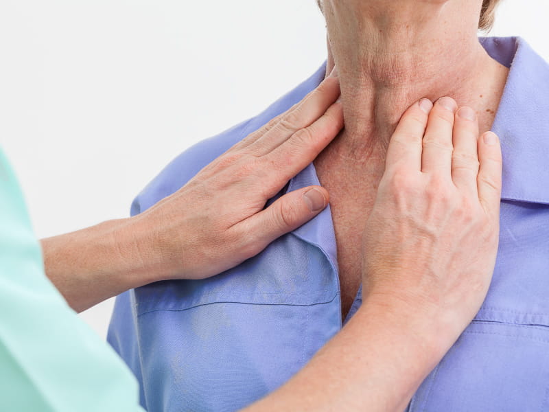 Doctor examining man's neck. photographee.eu, depositphotos