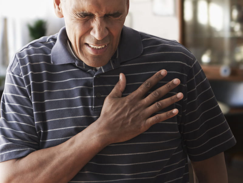 African-American man clutching his chest. (iStock)