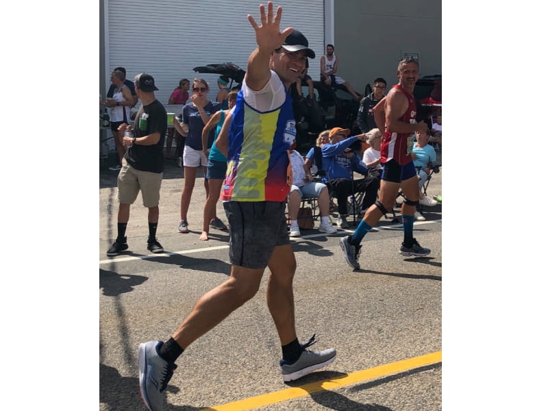 Tedy Bruschi waves as he runs in Falmouth, Mass. (Photo courtesy of Tedy's Team)