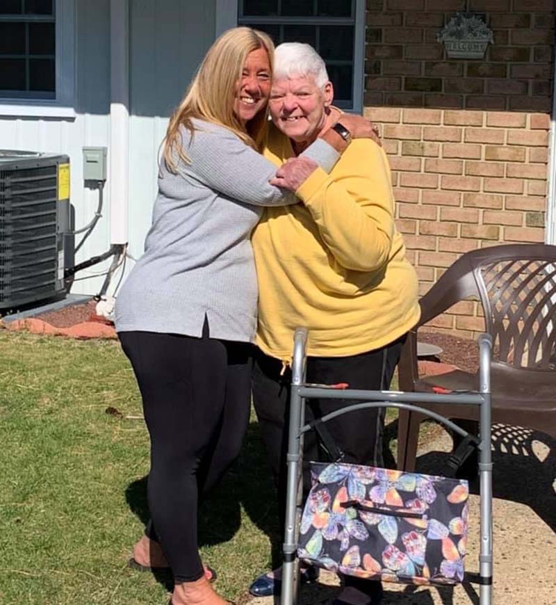 Abby Stopfer Lundy, left, hugs her mother, Barbara Stopfer, for the first time in more than a year, since pandemic lockdowns began. (Photo courtesy of Abby Stopfer Lundy)