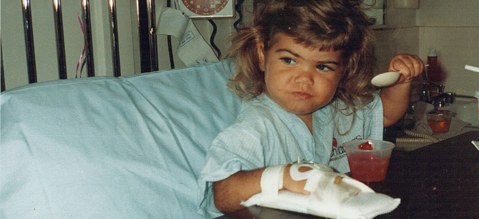 Kendra Plumley in a hospital bed, shortly after getting a heart transplant at 21 months old.