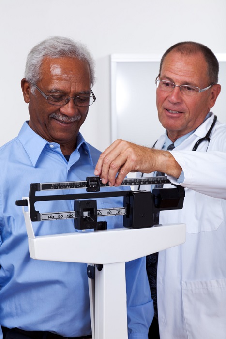 Doctor weighing man