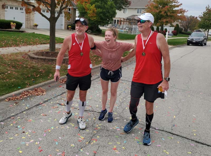 Molly Fitzgerald (center) ran the final mile of the race her dad organized, Miles with a Purpose. She crossed the finish line with her dad, Don (left) and uncle, Jim Haack. (Photo courtesy of Molly Fitzgerald)
