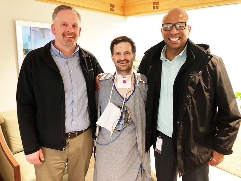 Scott Kern (center) with Dan Hay (left) and Jermaine Bennett – the men who saved his life by performing CPR and using an AED. (Photo courtesy of Trisha Kern)