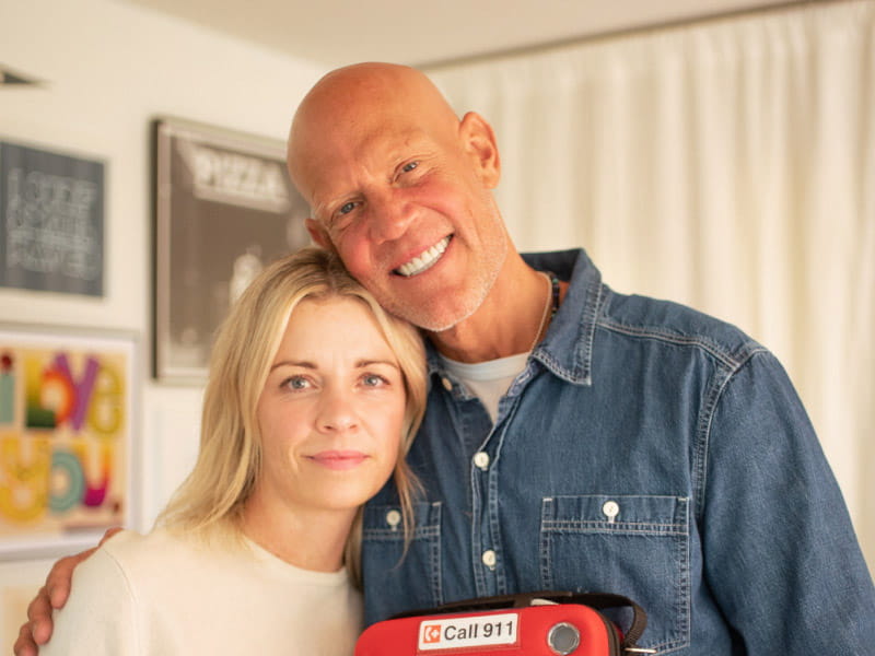 Former Grand Slam champion Murphy Jensen is an expert in overcoming. A year ago this week, he went into cardiac arrest and didn’t breathe on his own for 18 minutes, his latest death-defying episode. He's pictured with his wife, Kate, and the AED they keep at their house. (American Heart Association)