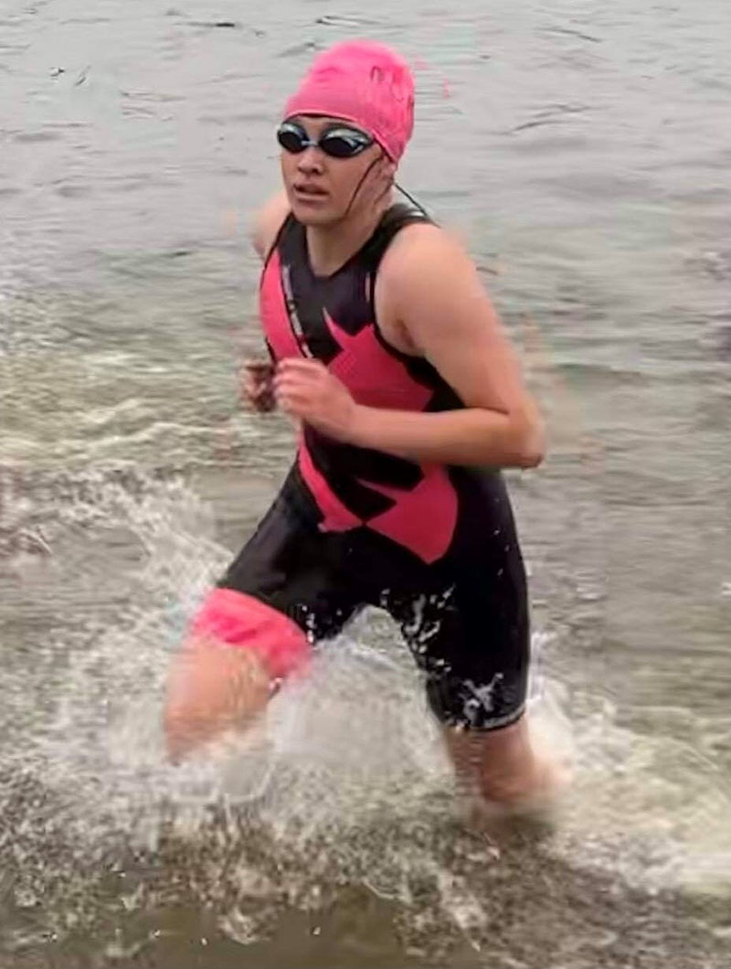 Anna emerging from the water following a 1.2-mile swim at the start of the Ironman 70.3 Ohio in July. (Photo courtesy of the Volpp family)