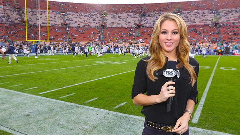 Jen Hale reporting on the sidelines of an NFL game. (Photo courtesy of Fox Sports)