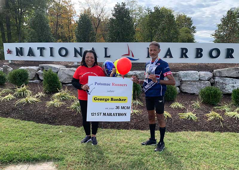 Bernadette and George Banker celebrate his 36th running of the Marine Corps Marathon, his 121st marathon overall and the fourth of his streak during the pandemic. (Photo courtesy of George Banker)