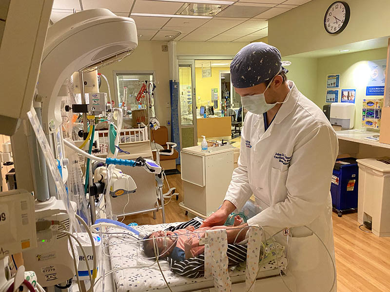 John checks on baby Alex. (Photo courtesy of Children’s Hospital Los Angeles)