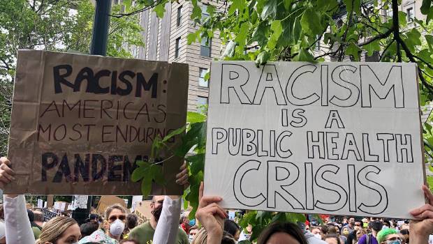 People holding stop racism signs