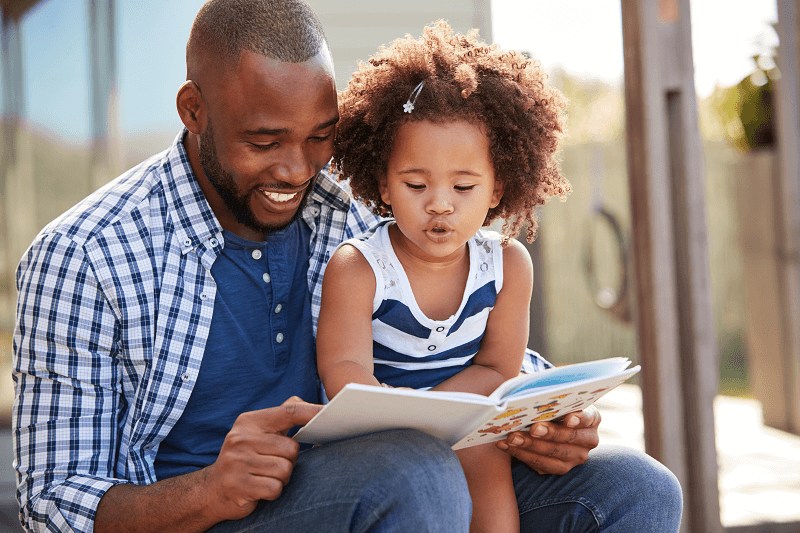 Young Father Reading to Daughter