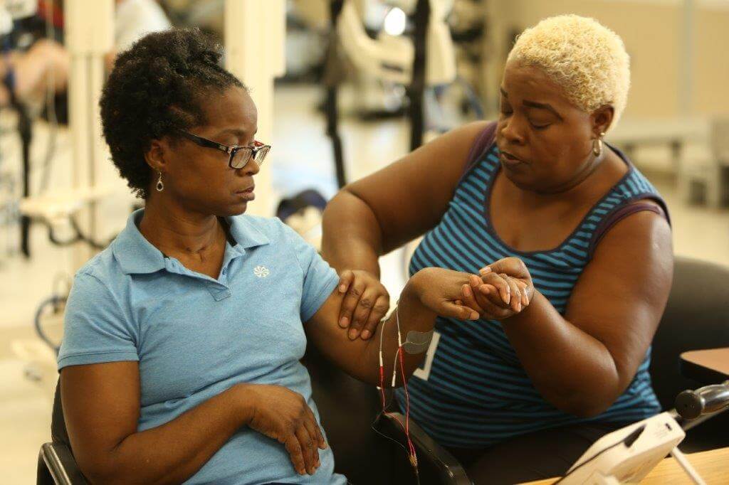 Women working on arm exercises in Stroke Rehab Setting