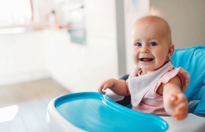 happy baby in a high chair