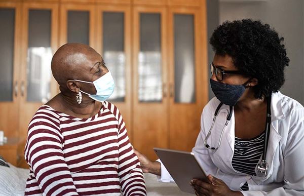 masked female patient and doctor