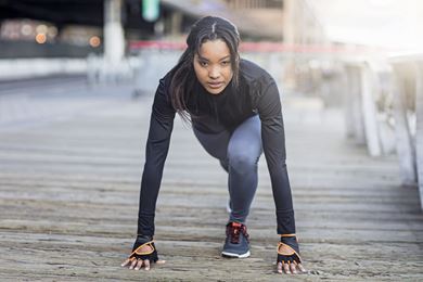 woman crouched down and ready to run