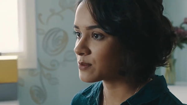 a video screen shot of stroke survivor, Rachel Castro, a young Latina woman in a home setting