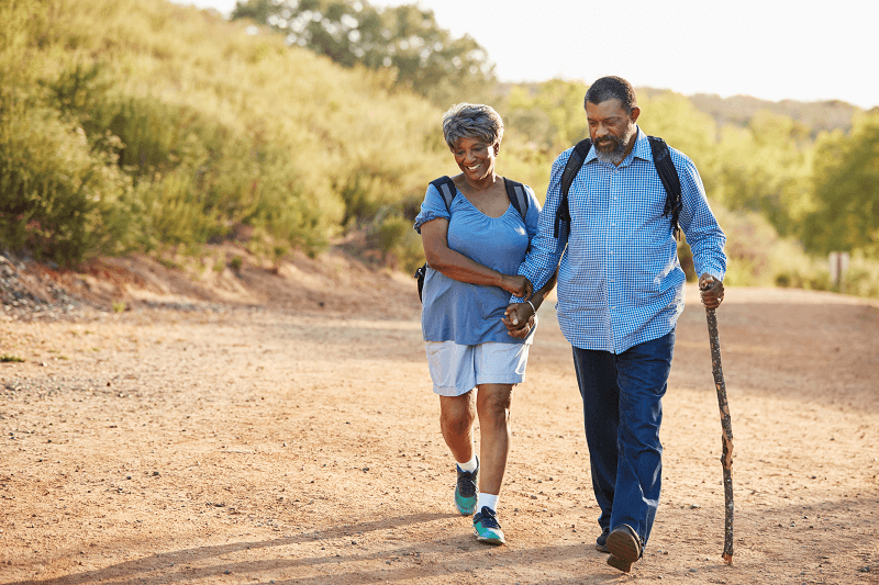 senior couple walking down a road