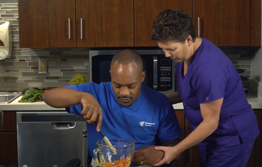 home health aide and patient cooking together