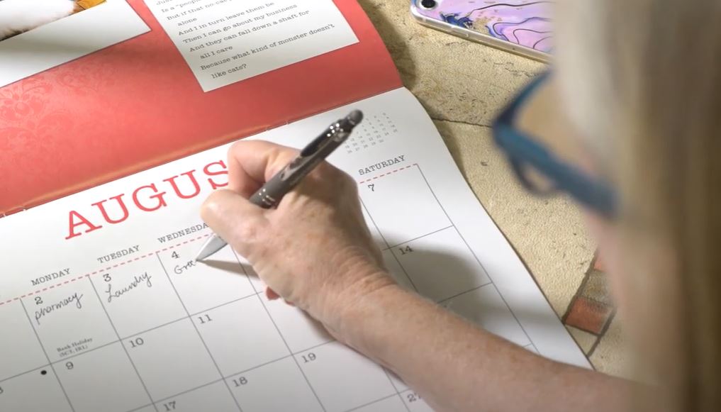 Woman planning her week on a calendar