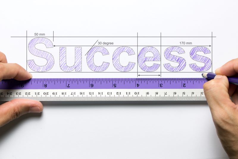 the word success written above a ruler