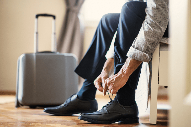 man sitting down tying his shoes