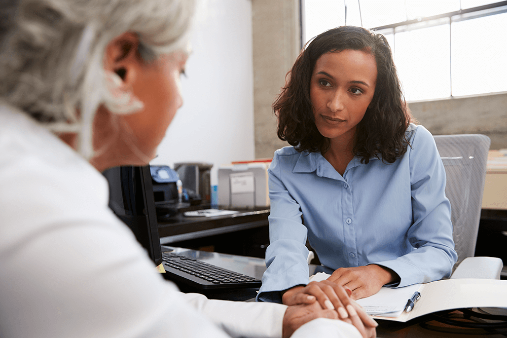 Concerned female doctor counselling senior woman