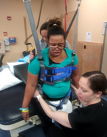 Stroke survivor, Dr. Christine Cosby-Gaither, in physical therapy at a rehab facility. (Photo courtesy of Christine Cosby-Gaither)