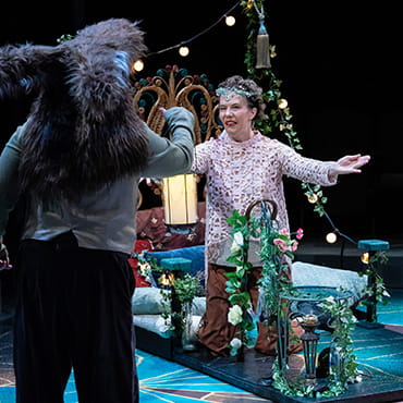 Maggie Whittum is on stage acting out a scene in a play.