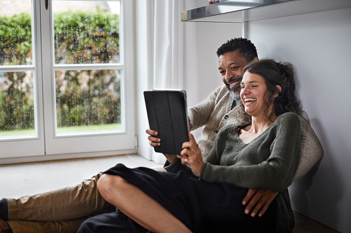 Man and woman reading a tablet together