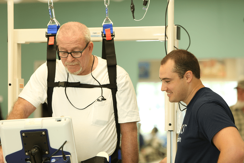 Older Man working in a rehab setting