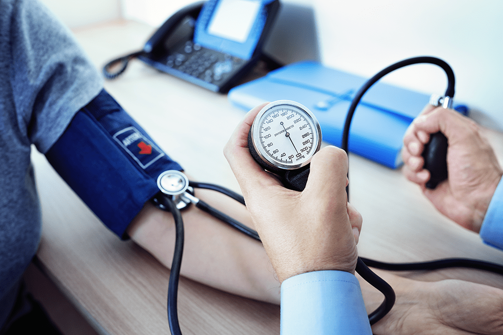 doctor measuring blood pressure of patient