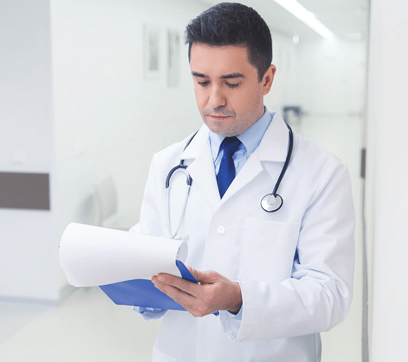 Doctor writing on a clip board