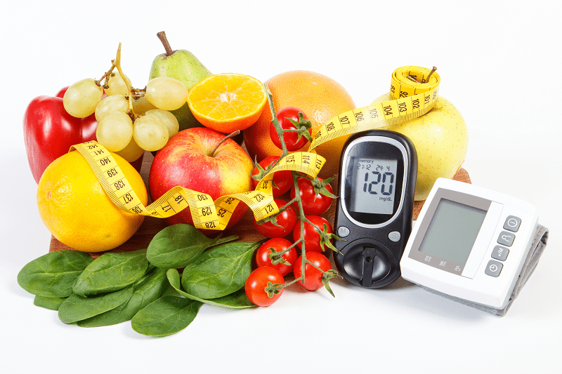 Fruit, tape measure, blood pressure machine and glucose monitor
