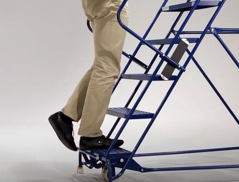 A person is stepping up on a folding staircase.