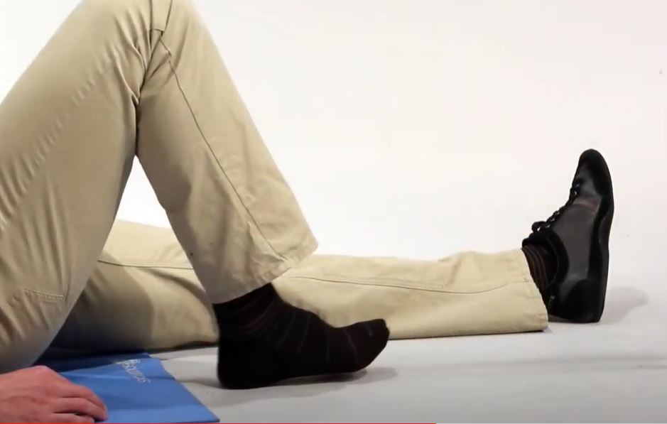 A left leg is outstretched while the right leg is bent with the foot flat on the ground.