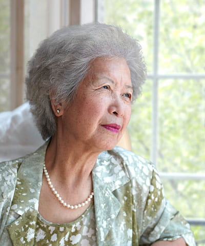 Chinese woman sitting post stroke