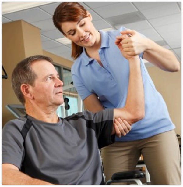 Physical therapist lifting a patient's arm