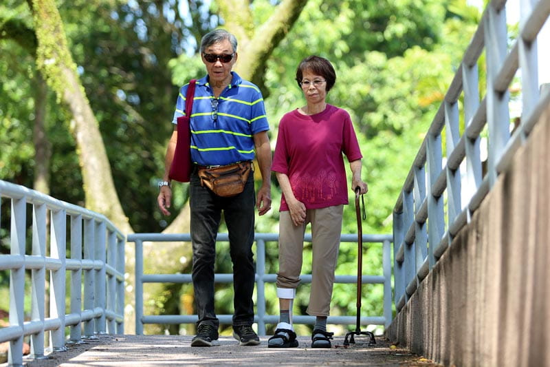 Senior couple walking as part of stroke rehabilitation