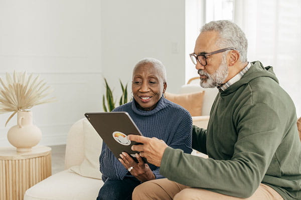 Senior couple looking at information on a tablet together