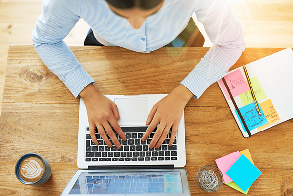 top down view of woman typing on laptop