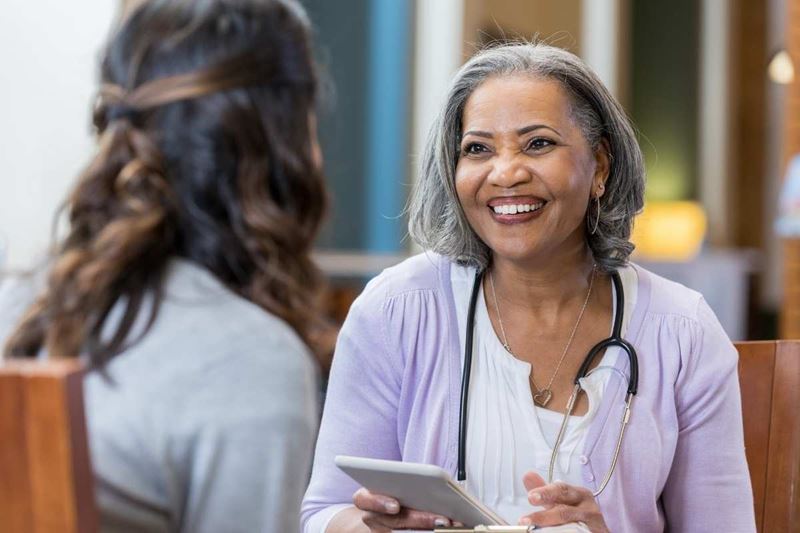 senior medical care worker consulting with woman